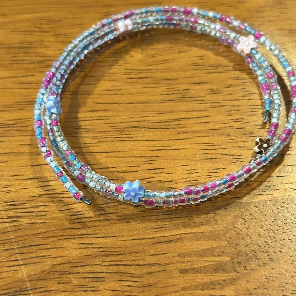 Handmade seed bead bracelet. Stretchy. Pink blue flowers.